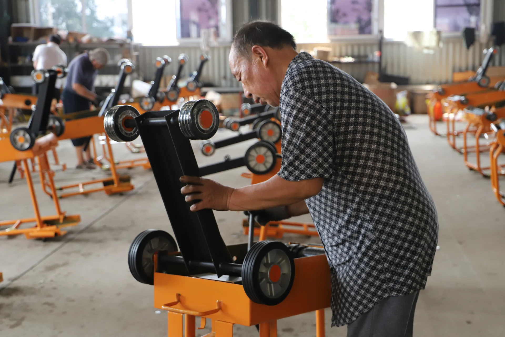 Technician working on machine components in the IDEAL workshop