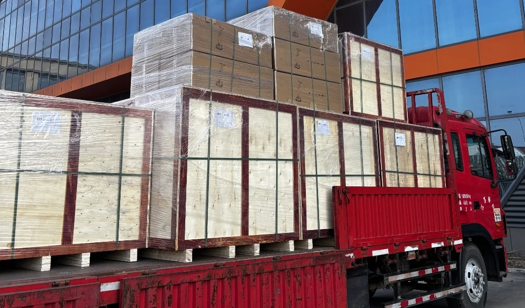 Strapped wooden crates on a delivery truck outside the factory